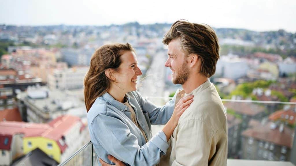 A smiling couple standing close together 