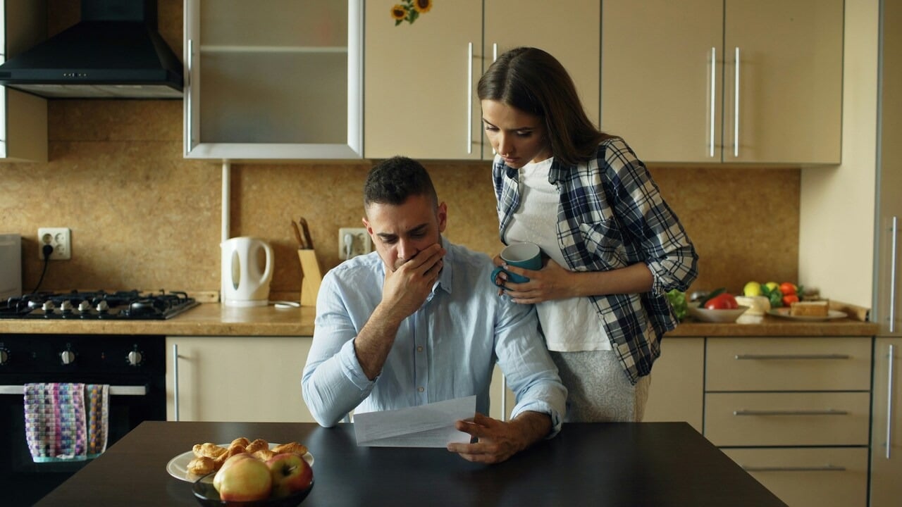 A couple looking stressed by the bills