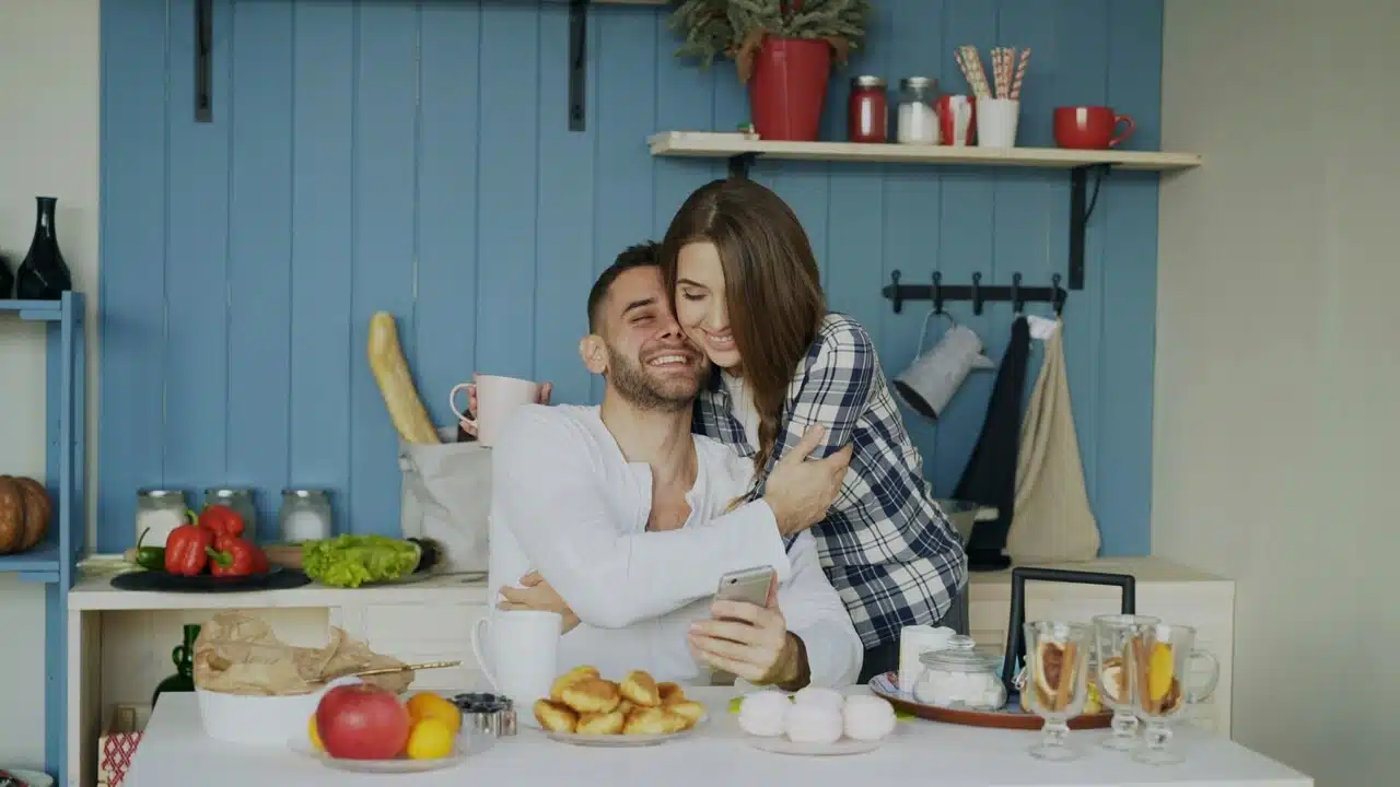 A couple hugging in the kitchen