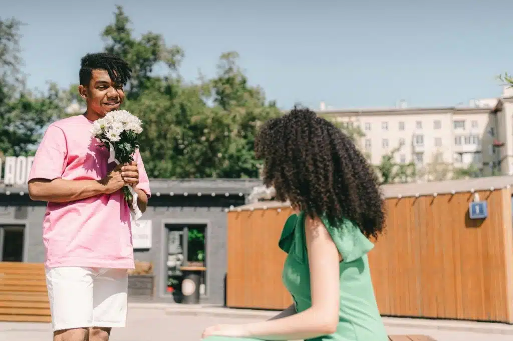 A man giving a flower to woman