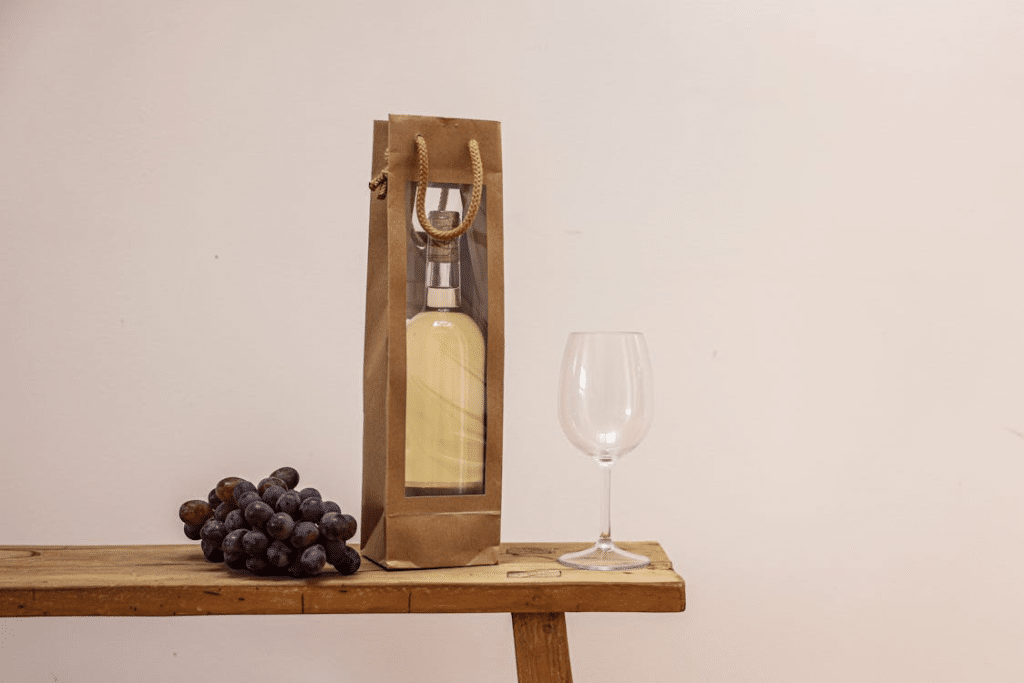 A photo of wine with grapes and a glass
