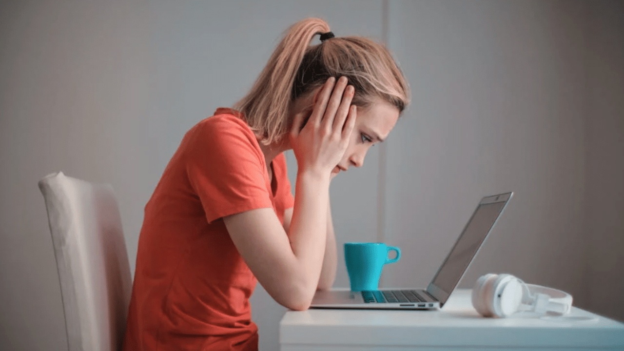 A woman looking devastated at home