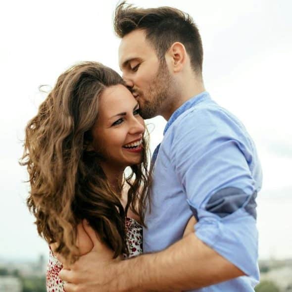 A couple embracing and smiling