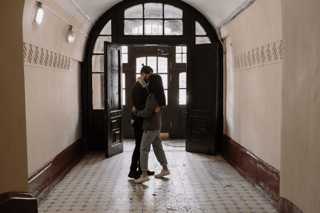 A couple hugging in the hallway