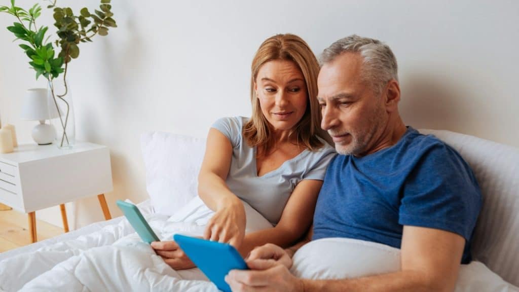 A blonde haired wife recommending the best variant for husband shopping online.