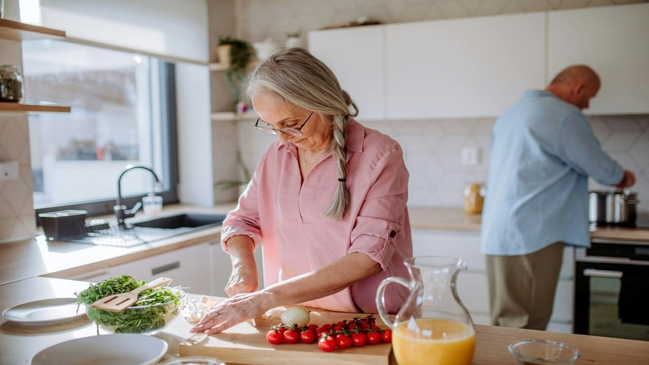 A senior couple cooking together