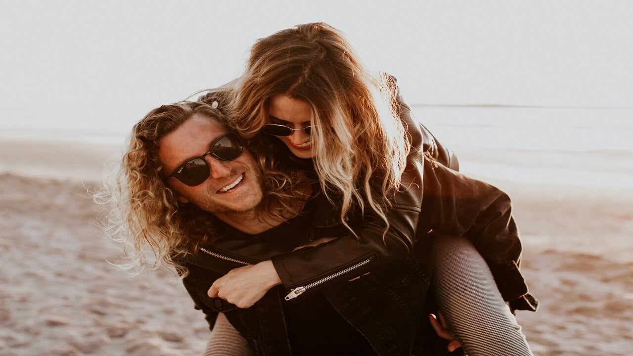 A couple looking happy by the beach