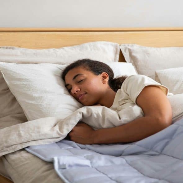 A woman using a weighted blanket