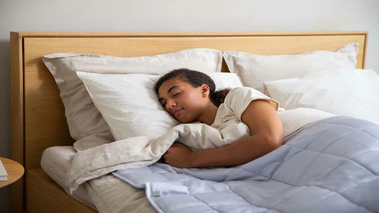 A woman using a weighted blanket