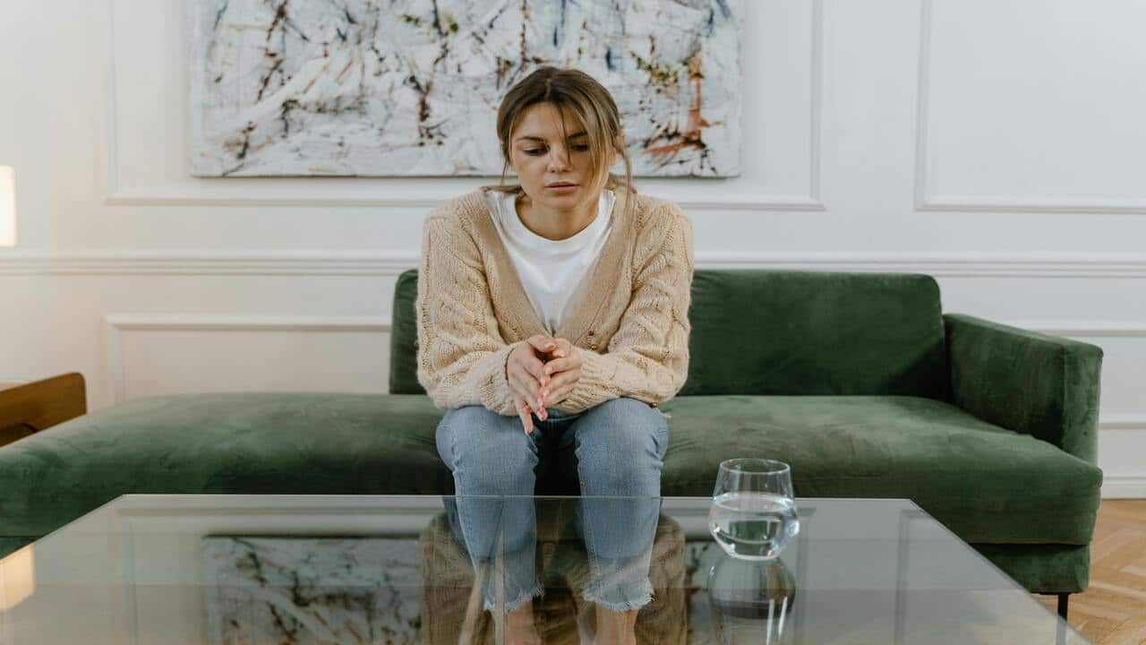 A woman looking sad at home 
