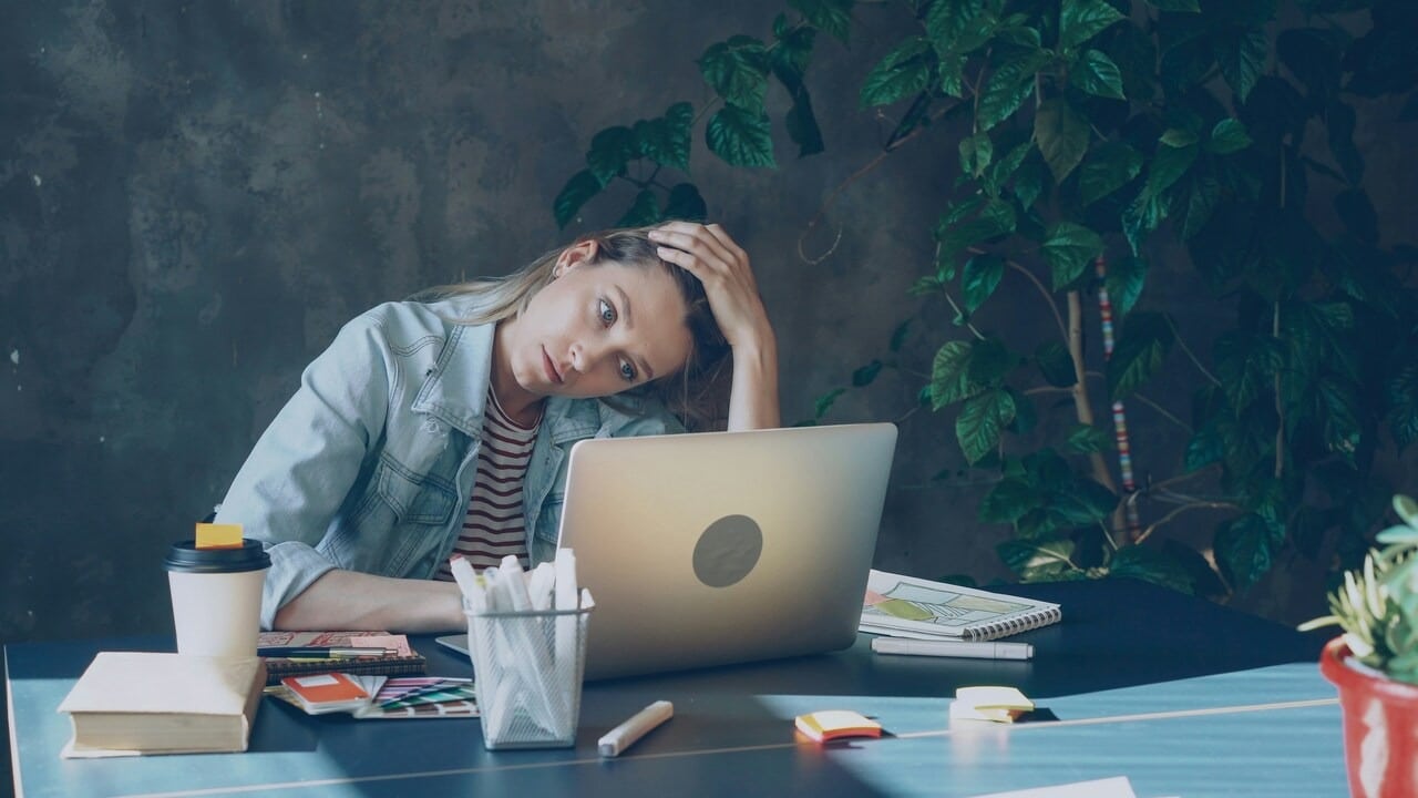 A woman looking stressed at work