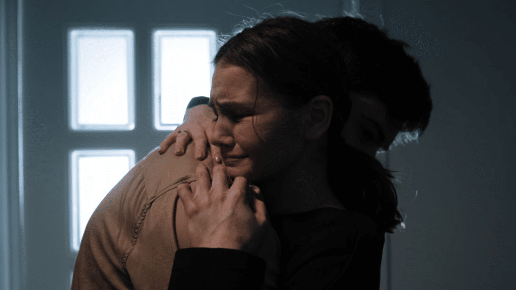 A man comforting his crying wife