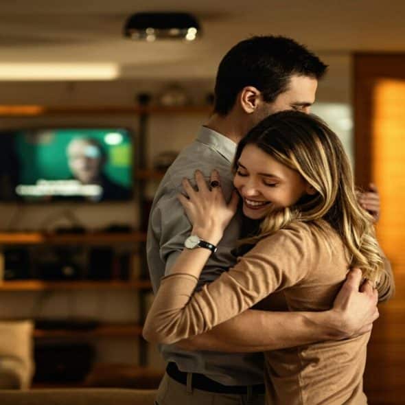 A couple hugging in the living room