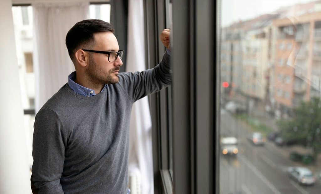 Alt text: eflective male alone indoors