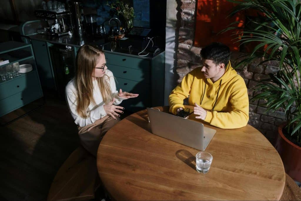 A woman addressing problems to a man