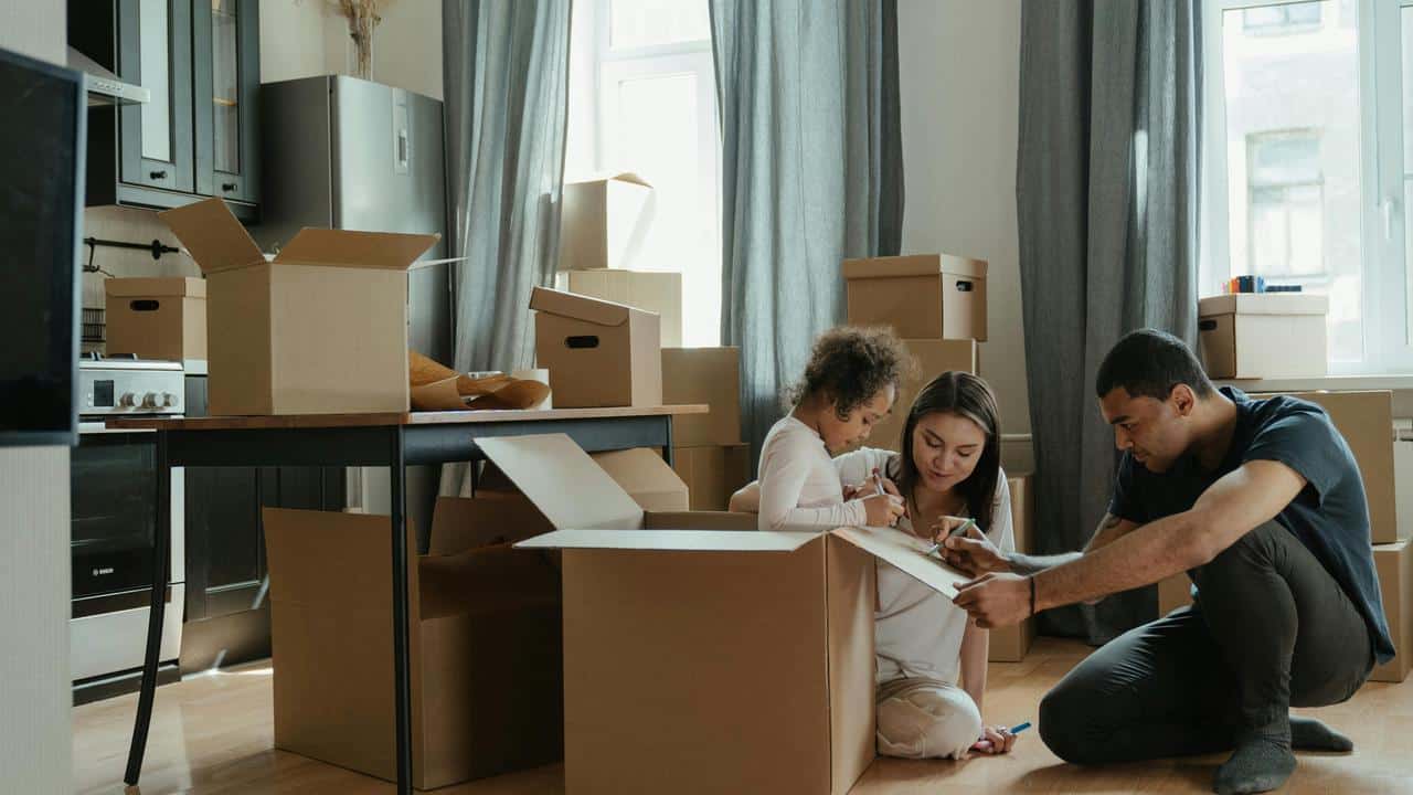 A family unpacking boxes together in their new home.