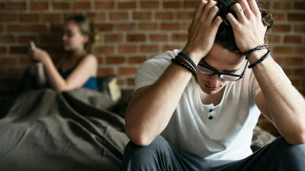 A woman is busy on her phone, leaving her partner alone.