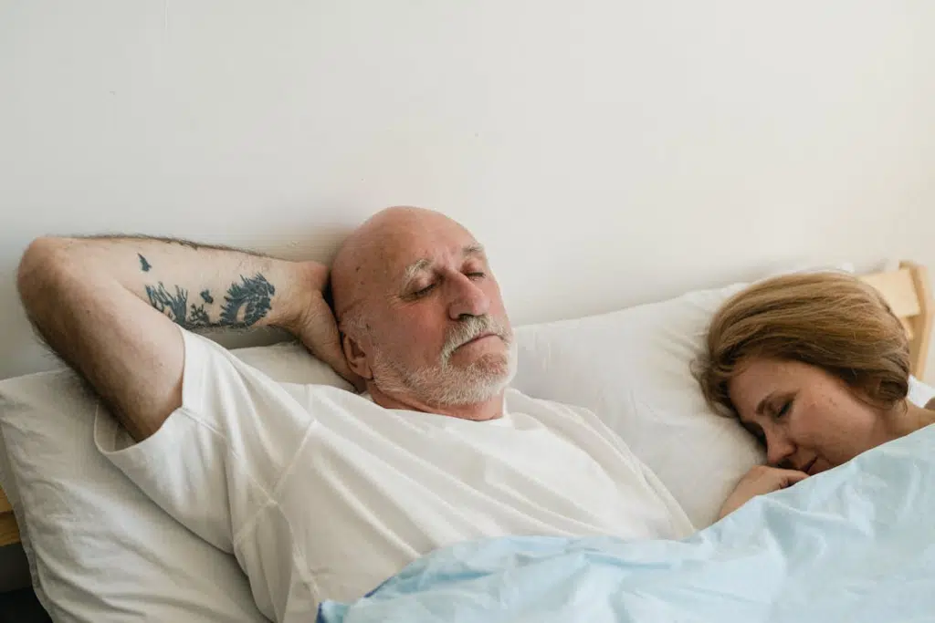 A Couple Sleeping on the Bed