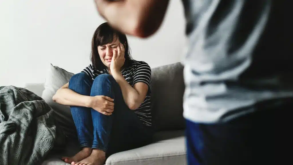 Unhappy couple arguing on the sofa.