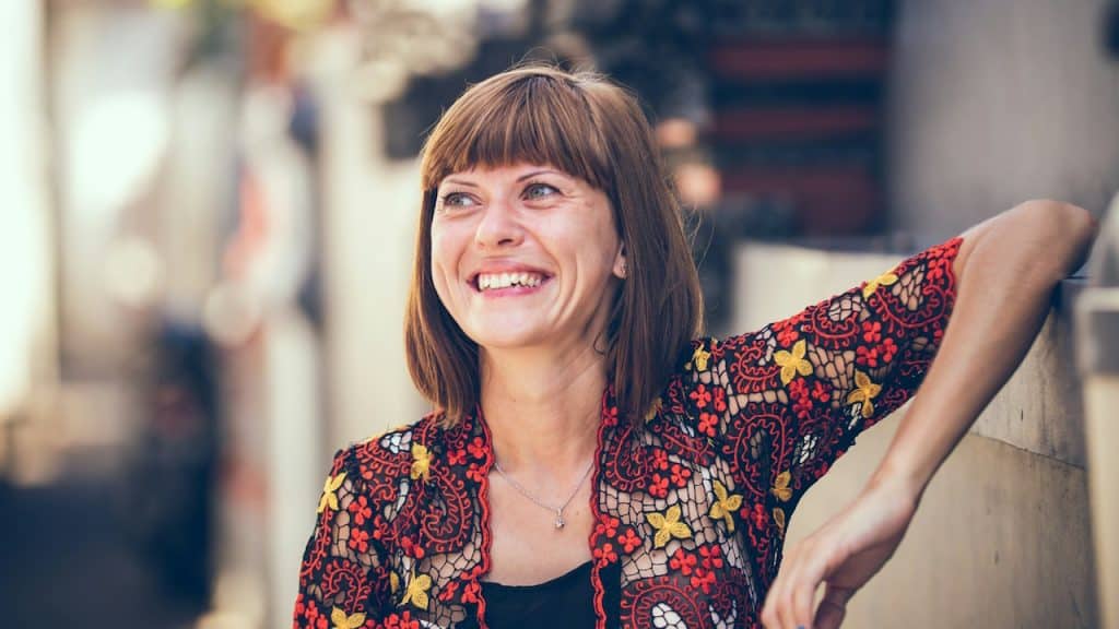 A mature woman smiling.