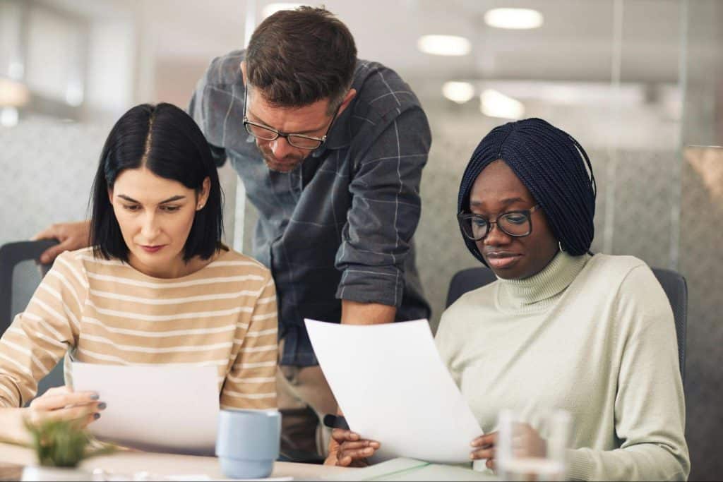 A man checking colleague’s work