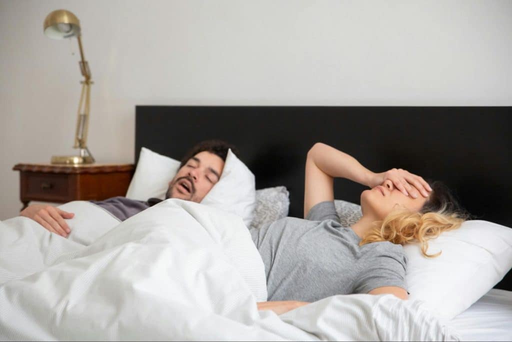 A man and woman at the bed