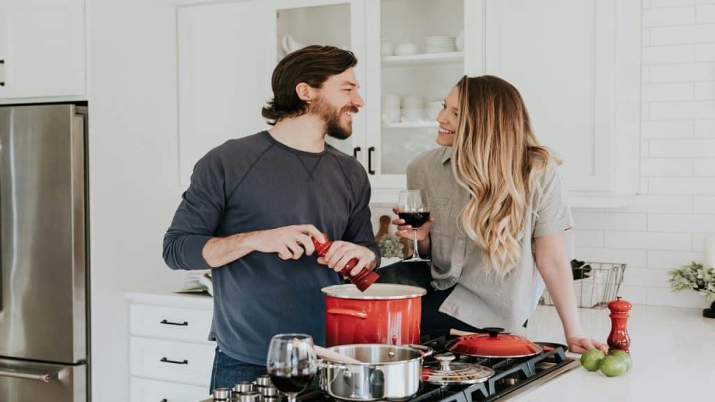 A couple laughing in the kitchen
