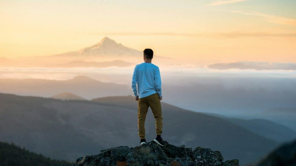 A man standing at the top of a hill.