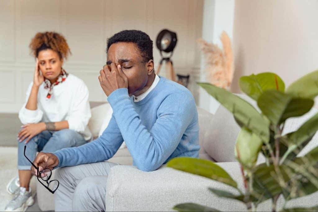 A man holding his nose out of frustration