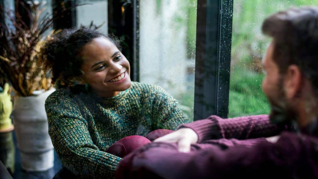 A couple talking by the window