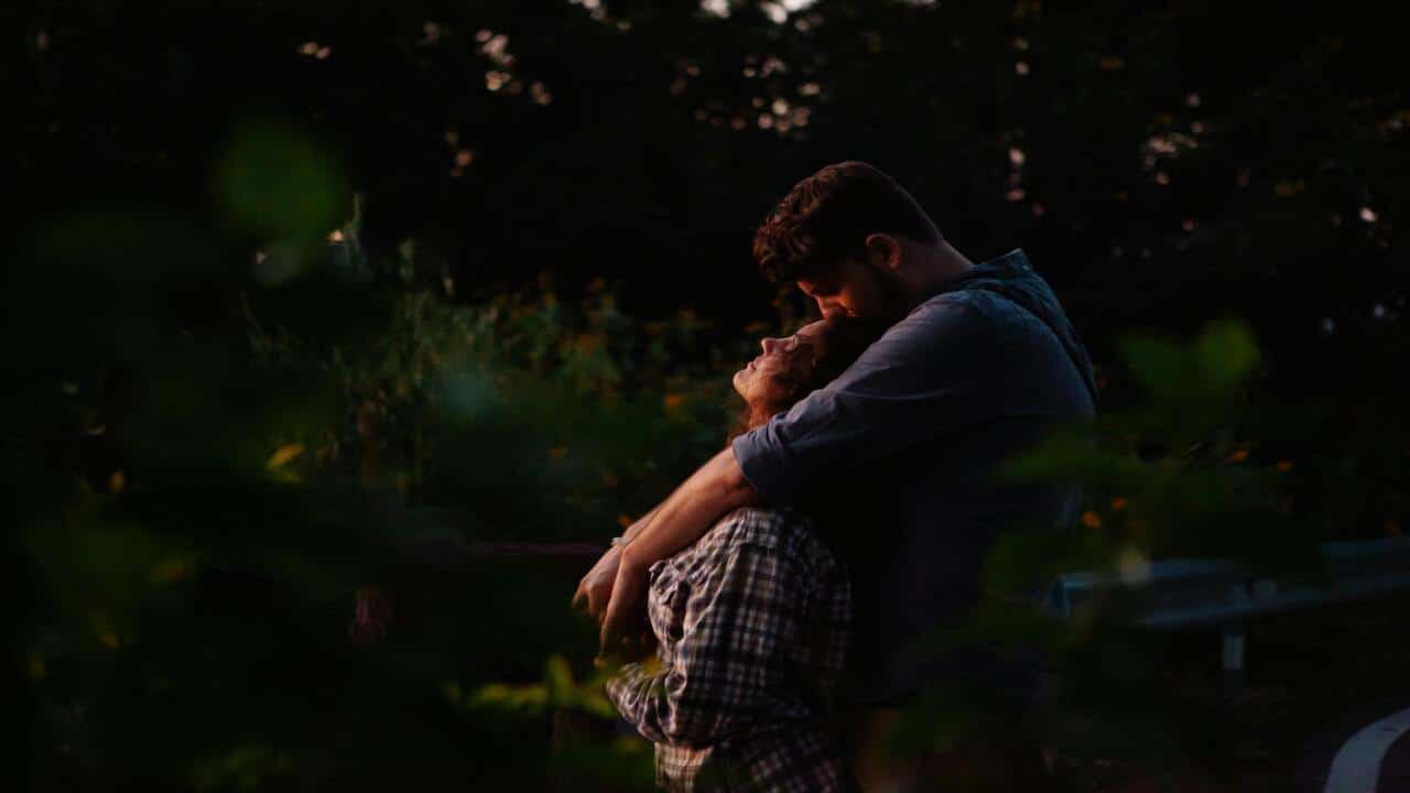 A couple hugging at sunset