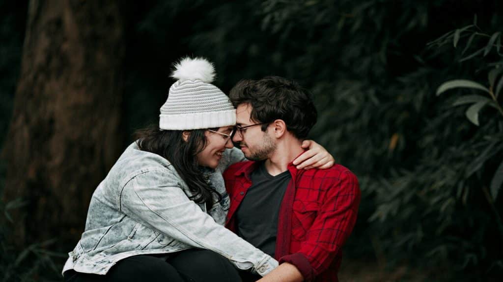 A couple cuddling in the woods