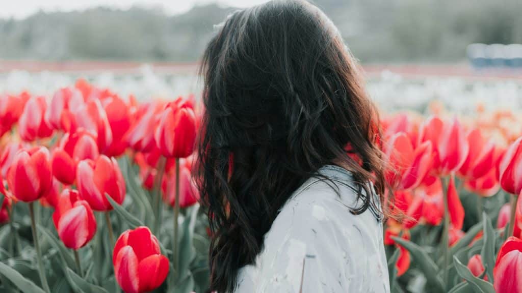 A woman standing in a flower field.
