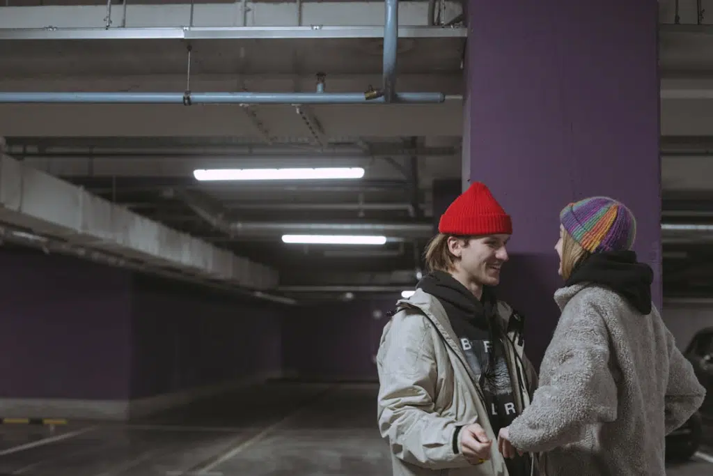 Couple flirting in a parking lot