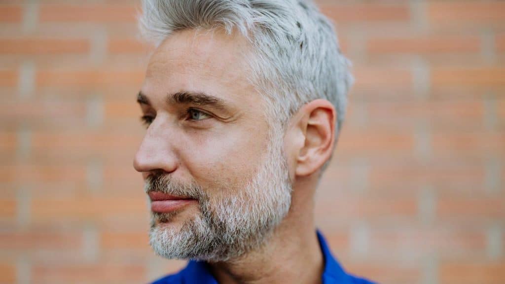 A man with a graying beard looking to the side.