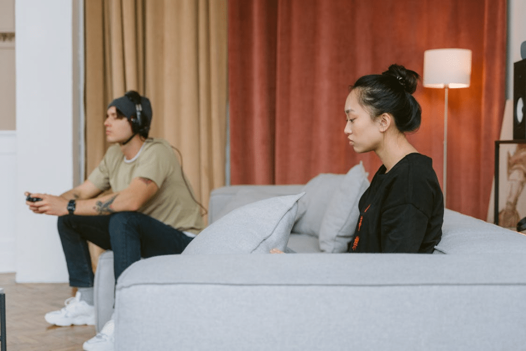 A Sad Woman Sitting on a Couch Near a Man