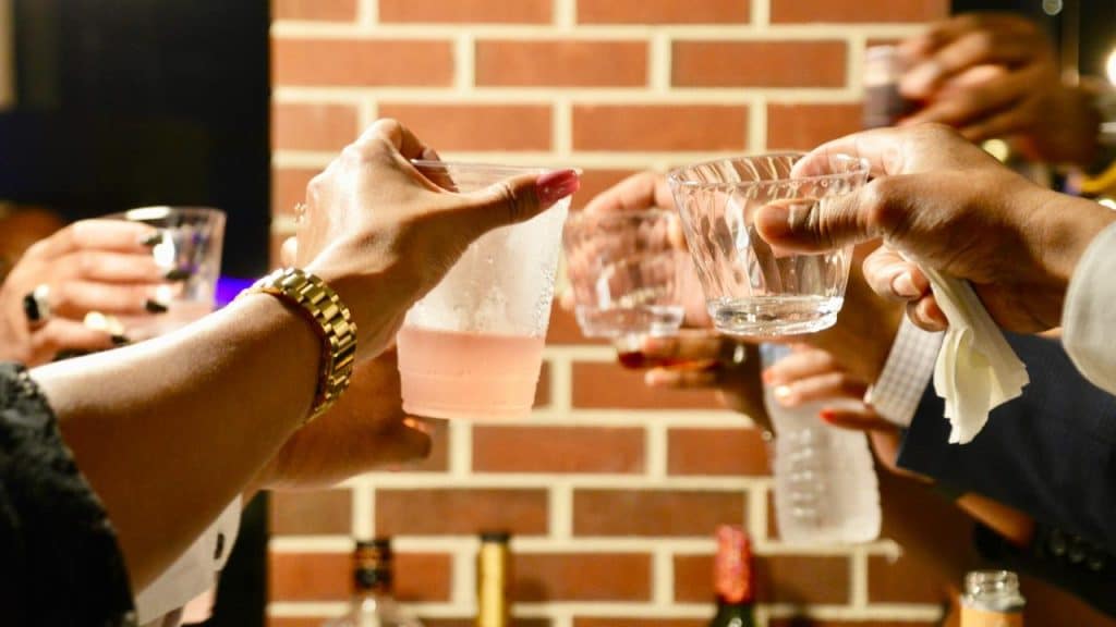 A group of people raising glasses for a toast.