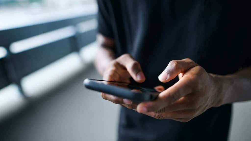 A person using a smartphone outdoors.