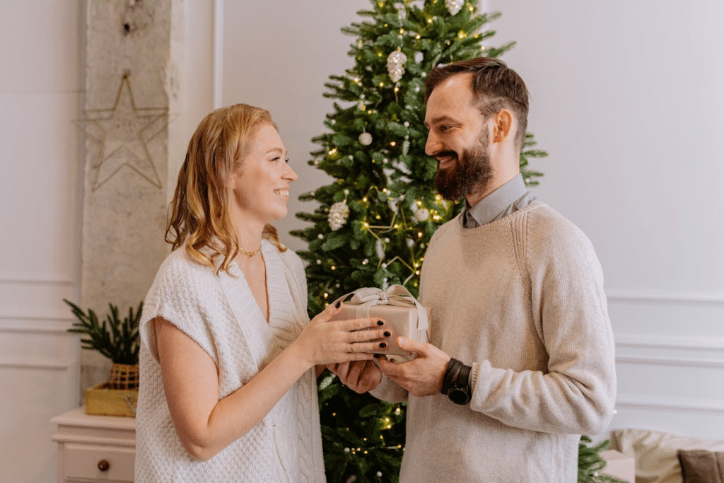 Woman giving gift to man