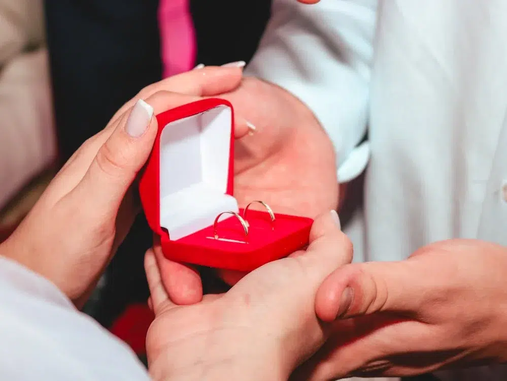 A man giving jewelry to a woman
