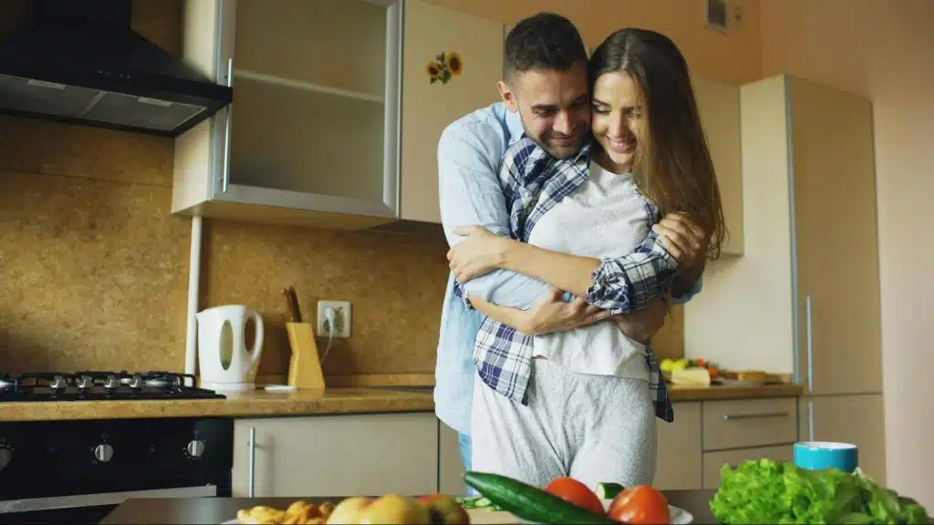 A man hugging a woman