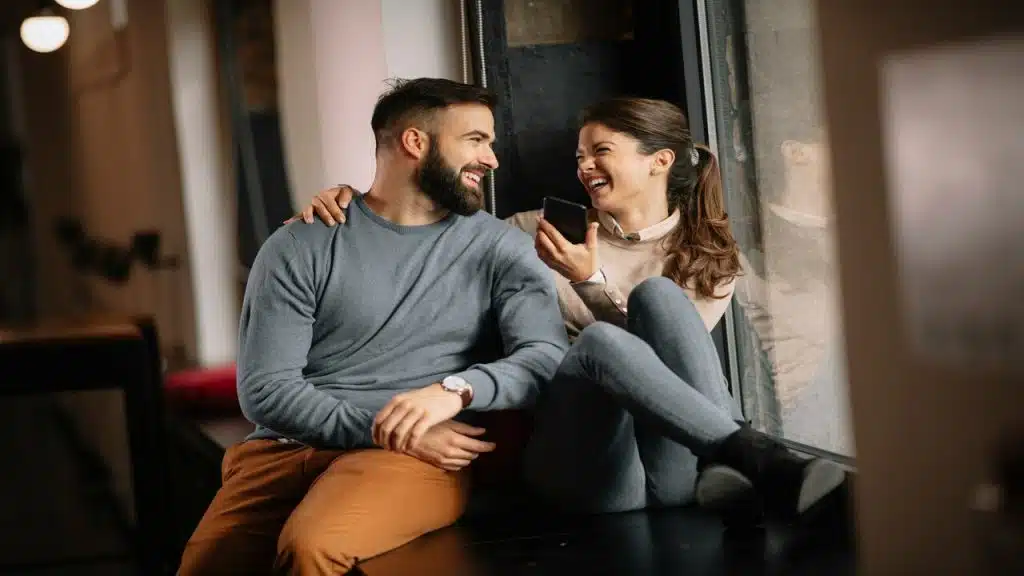 A couple laughing at home