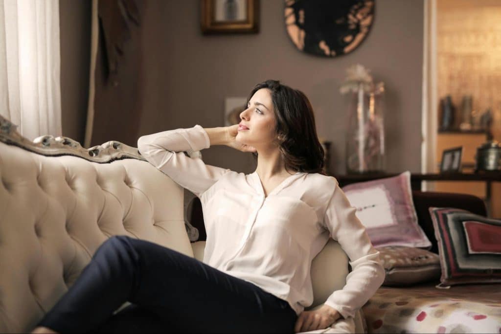 A woman sitting at the sofa