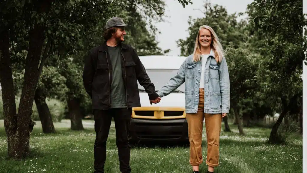 A man and a woman holding hands, standing next to each other.