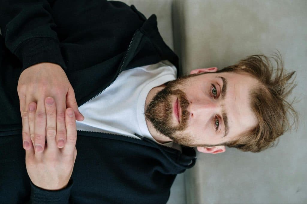 A man thinking while lying on the ground