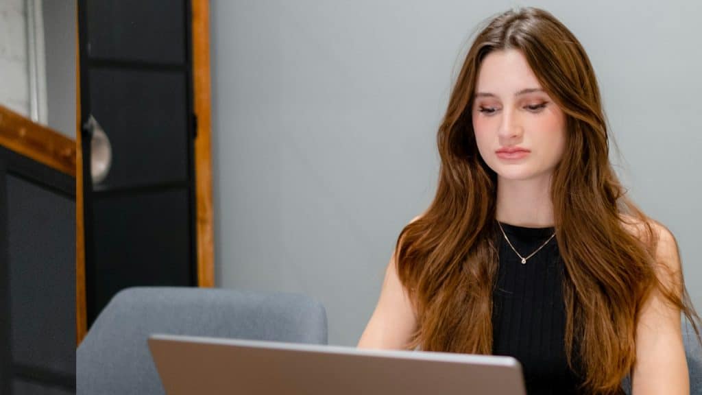 A woman looking at a computer screen.