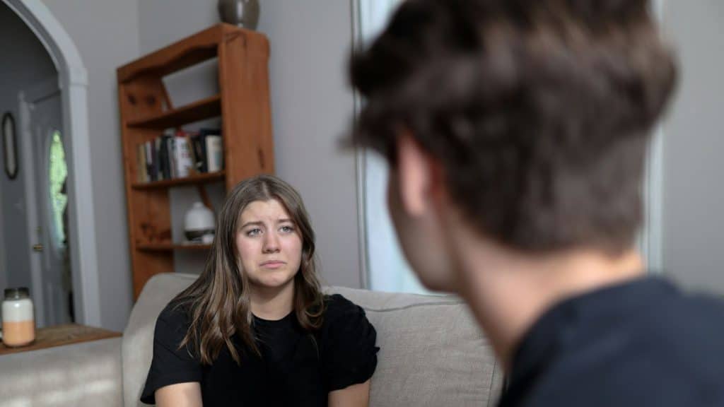 A sad woman talking to a man