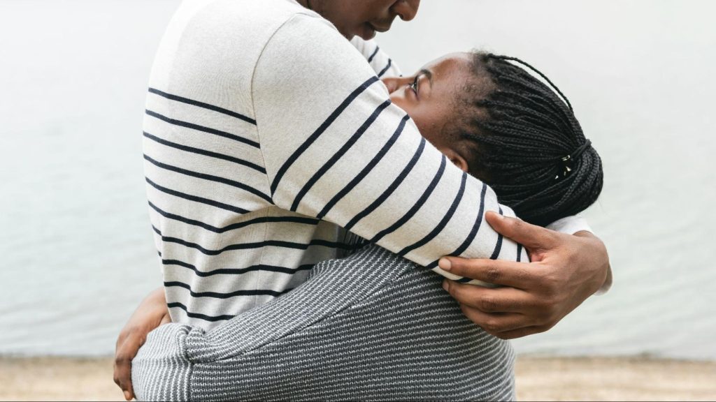 A man hugging a woman
