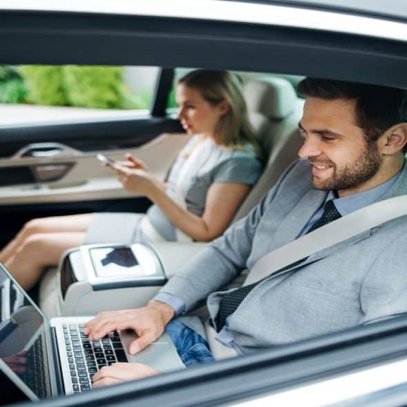 A couple in the backseat of a car