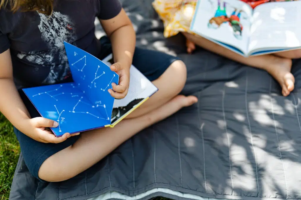 A woman holding a constellation book